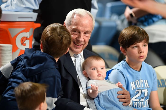 North Carolina Tar Heels head coach Roy Williams holds his granddaughter Kenzie Newlin before a game at Dean E. Smith Center.